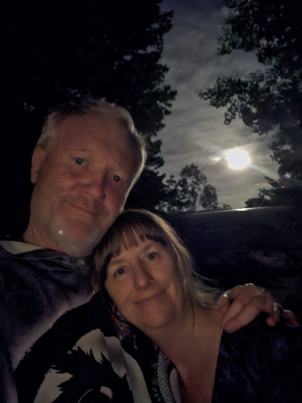 Shannon and Melissa under a full moon through the pines